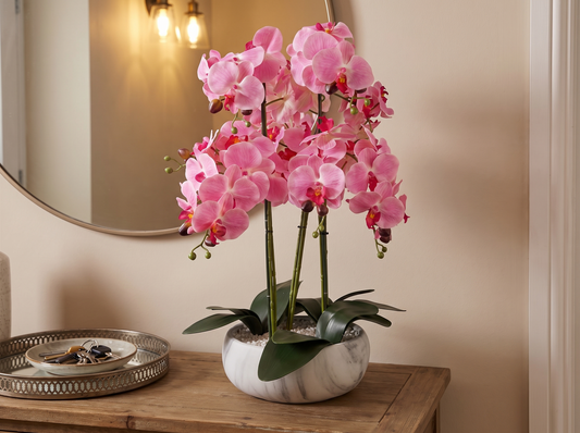 Pink Orchid in Marble-Effect Ceramic Planter on hallway console table
